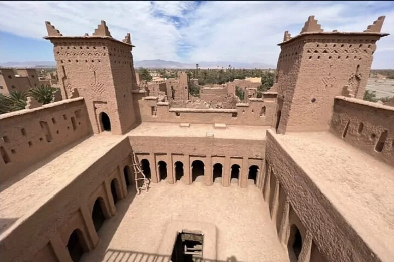 Interior courtyard showing the earthen architecture of a historic Skoura kasbah